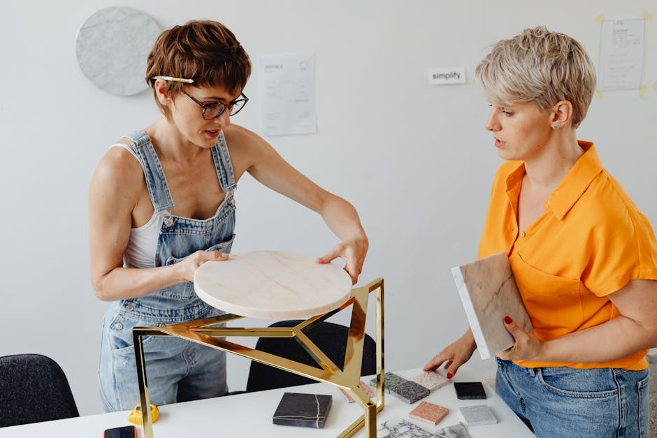 Two women collaborating on a design project with marble samples.